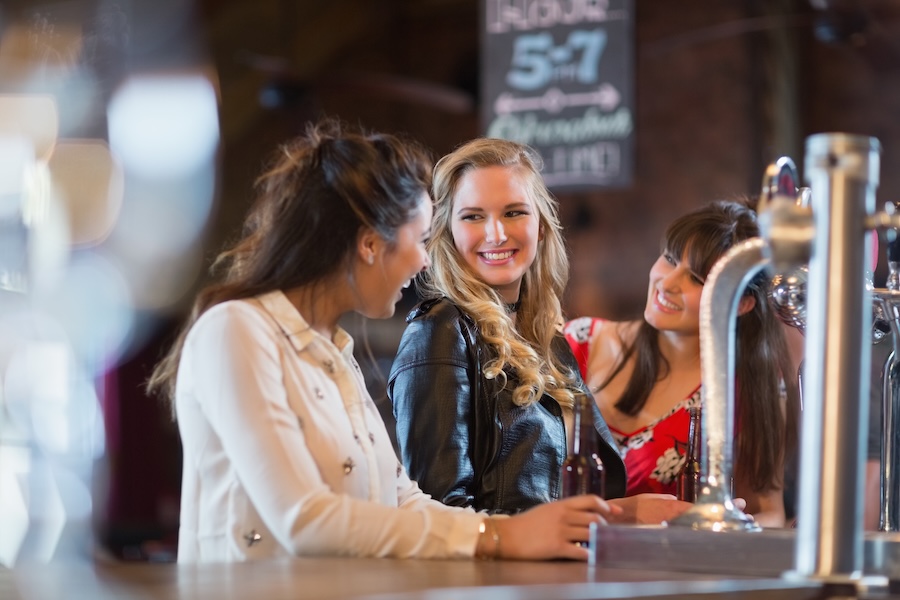 smiling females standing by bar counter 2025 04 03 21 17 50 utc